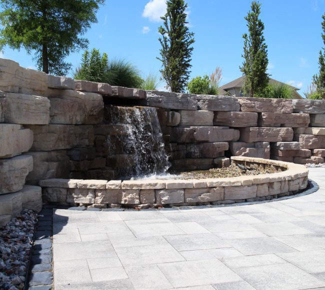 A patio with wicker furniture and a fire pit.