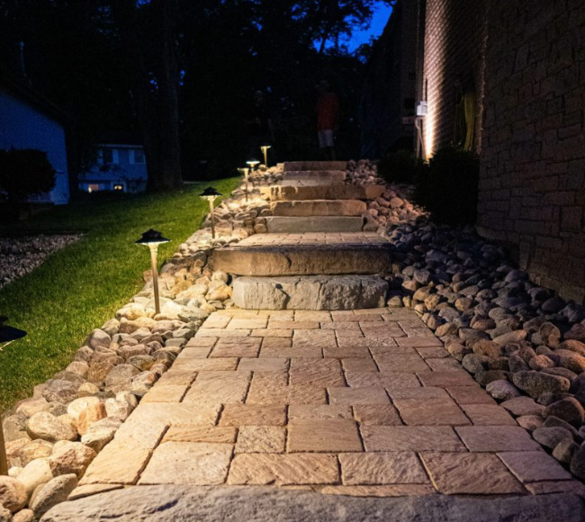 A front yard with a stone walkway and landscaping.